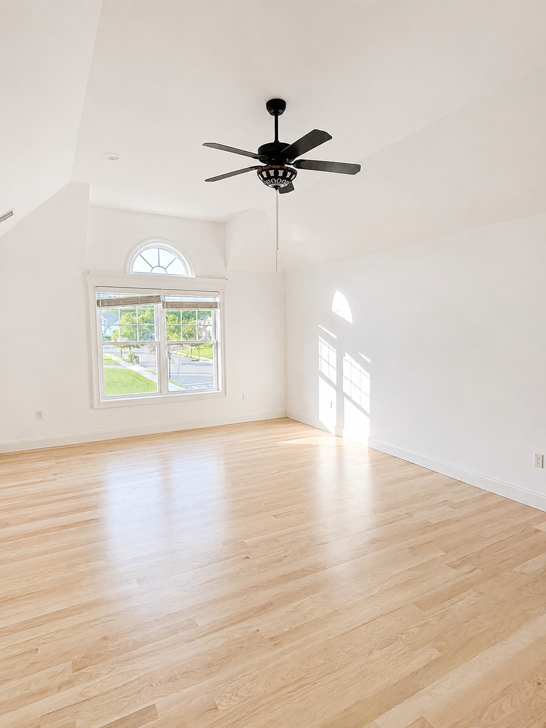 Finished open-plan room with new light-oak flooring and freshly painted walls, showing how the floor and wall color work together.